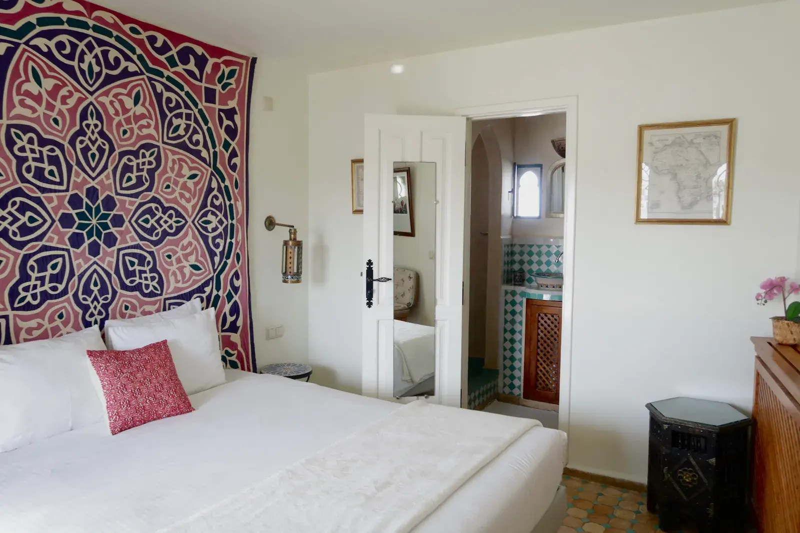 Spacious senior suite with vintage map wall art and traditional furnishings at Kasbah Rose Tangier