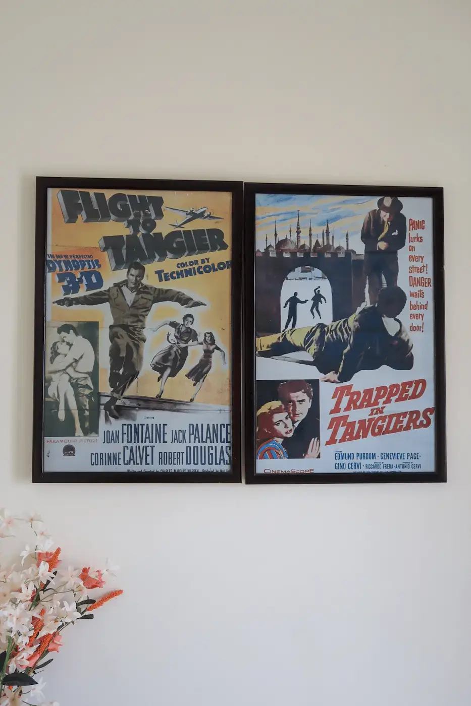 Vintage movie posters Flight to Tangier and Trapped in Tangiers displayed on the wall of Room 1 at Kasbah Rose guesthouse, adding nostalgic cinematic charm to the traditional Moroccan decor